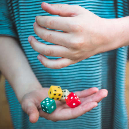 Midsection Of Girl Holding Dices